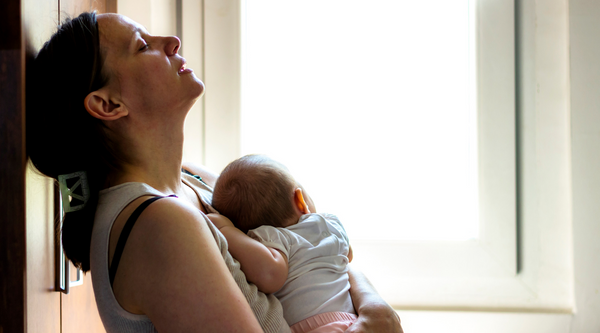 Tired mum with newborn